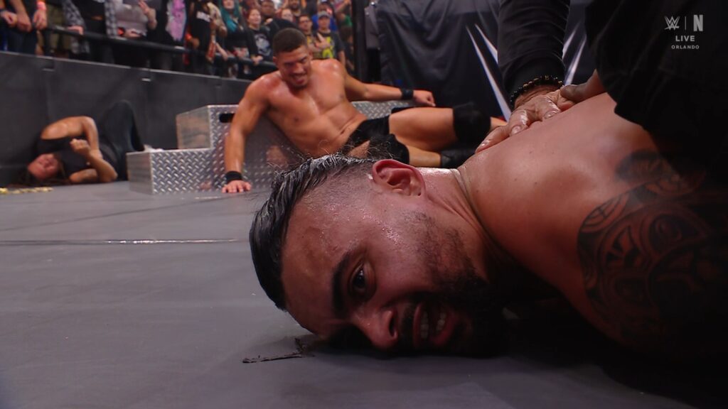 Cruz Montana is restrained face-down at ringside during his arrest on WWE NXT, October 20, 2026.