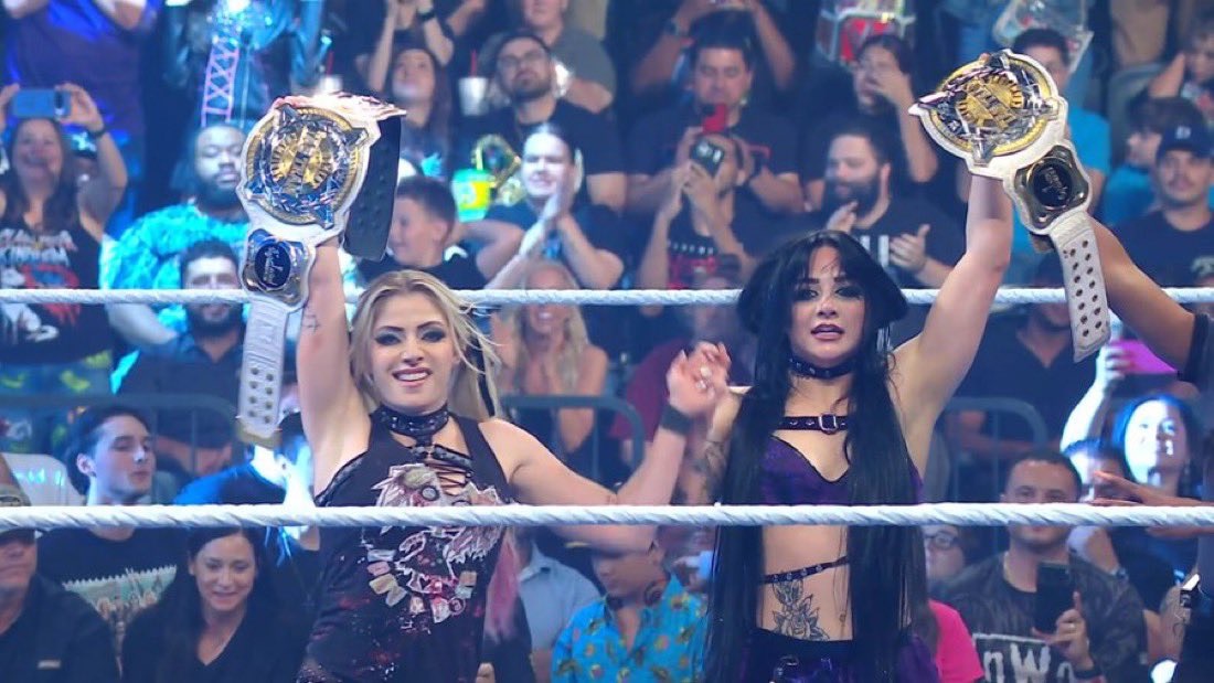 Alexa Bliis and Tatum Paxley celebrate winning the WWE Women's Tag Team Championship.