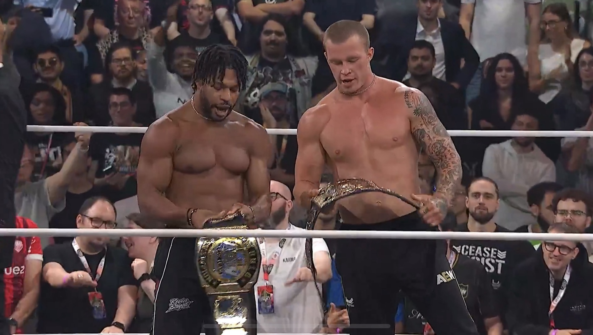 Kyle Fletcher and Kevin Knight holding the AEW World Tag Team Championship belts after attacking The Young Bucks.